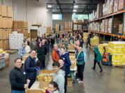 MINNEHAHA: More than 100 Kaiser Permanente employees from Southwest Washington and Oregon volunteered with their families and friends to sort 40,000 pounds of potatoes at the Clark County Food Bank on Martin Luther King Jr.