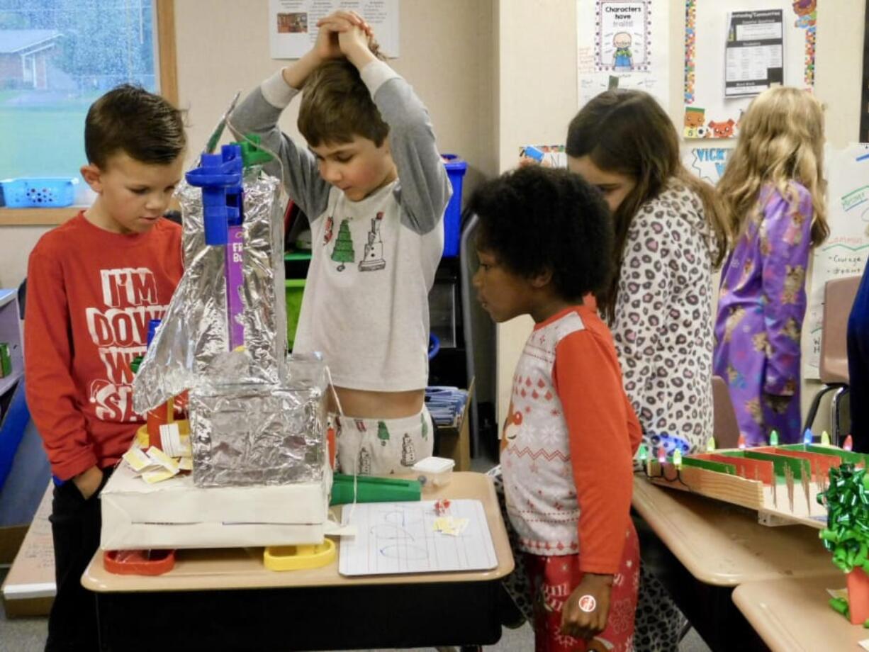 RIDGEFIELD: Union Ridge Elementary students watch a ball roll through a maze made of recycled tubes and boxes.