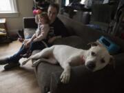 Pyperann Jones, 22 months, relaxes with her mother, Taylor Jones, and one of the family&#039;s dogs, Bonnie, 1, at their Vancouver home.