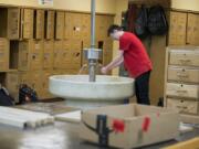 Ridgefield High School senior Jacob Scouller, 18, washes his hands in a sink from another era while joining classmates during wood class Thursday afternoon. The aging wood shop would be among the facilities impacted with the passing of the new bond, as the district eyes construction of a new vocational building.