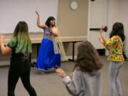 Monika Deshpande, center, teaches a dozen teens Bollywood dance moves at the Camas Public Library on Saturday afternoon.