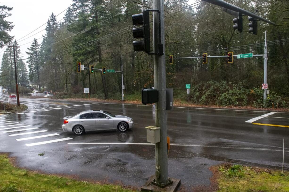 Traffic drives Jan. 23 through the intersection of Northeast Everett Street and Northeast Lake Road in Camas at the site of a proposed roundabout.