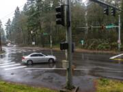 Traffic drives Jan. 23 through the intersection of Northeast Everett Street and Northeast Lake Road in Camas at the site of a proposed roundabout.