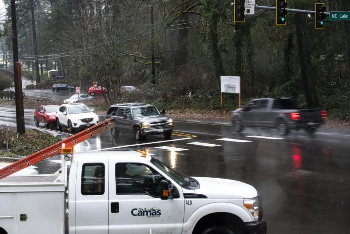 Cars pass through the intersection of Northeast Everett Street and Northeast Lake Road in Camas on Thursday at the site of a roundabout.