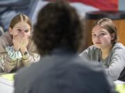 Madelyn Grimes, 11, left, and Melorah Crichton, 11, listen to Jeff Causey, a sixth-grade counselor at Discovery Middle School, during a social and emotional learning session on Monday.