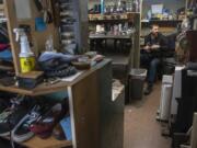 Vitaliy Gerasimov, owner of Totem Shoe Repair, works on the stitching for a pair of sneakers.