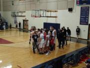 King's Way Christian boys basketball team celebrates its 56-50 win over La Center on Tuesday, Jan.