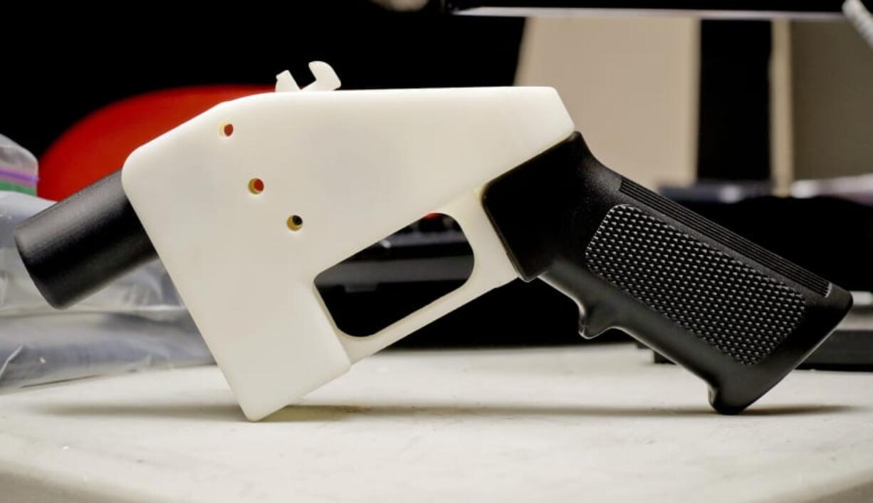 FILE- This Aug. 1, 2018 file photo, shows a 3D printed gun called the Liberator, in Austin, Texas.  Attorneys general in 20 states and the District of Columbia have filed a lawsuit challenging a federal regulation that could allow blueprints for making guns on 3D printers to be posted on the internet. A New York Attorney General Tish James is helping to lead the coalition, which filed the lawsuit Thursday.