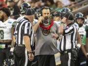 Hawaii head coach Nick Rolovich, center, speaks with the game officials in the second half of the Hawaii Bowl NCAA college football game, Tuesday, Dec. 24, 2019, in Honolulu.