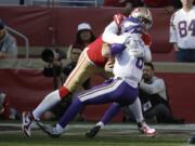 Minnesota Vikings quarterback Kirk Cousins, right, is sacked by San Francisco 49ers defensive end Arik Armstead during the first half of an NFL divisional playoff football game, Saturday, Jan. 11, 2020, in Santa Clara, Calif.