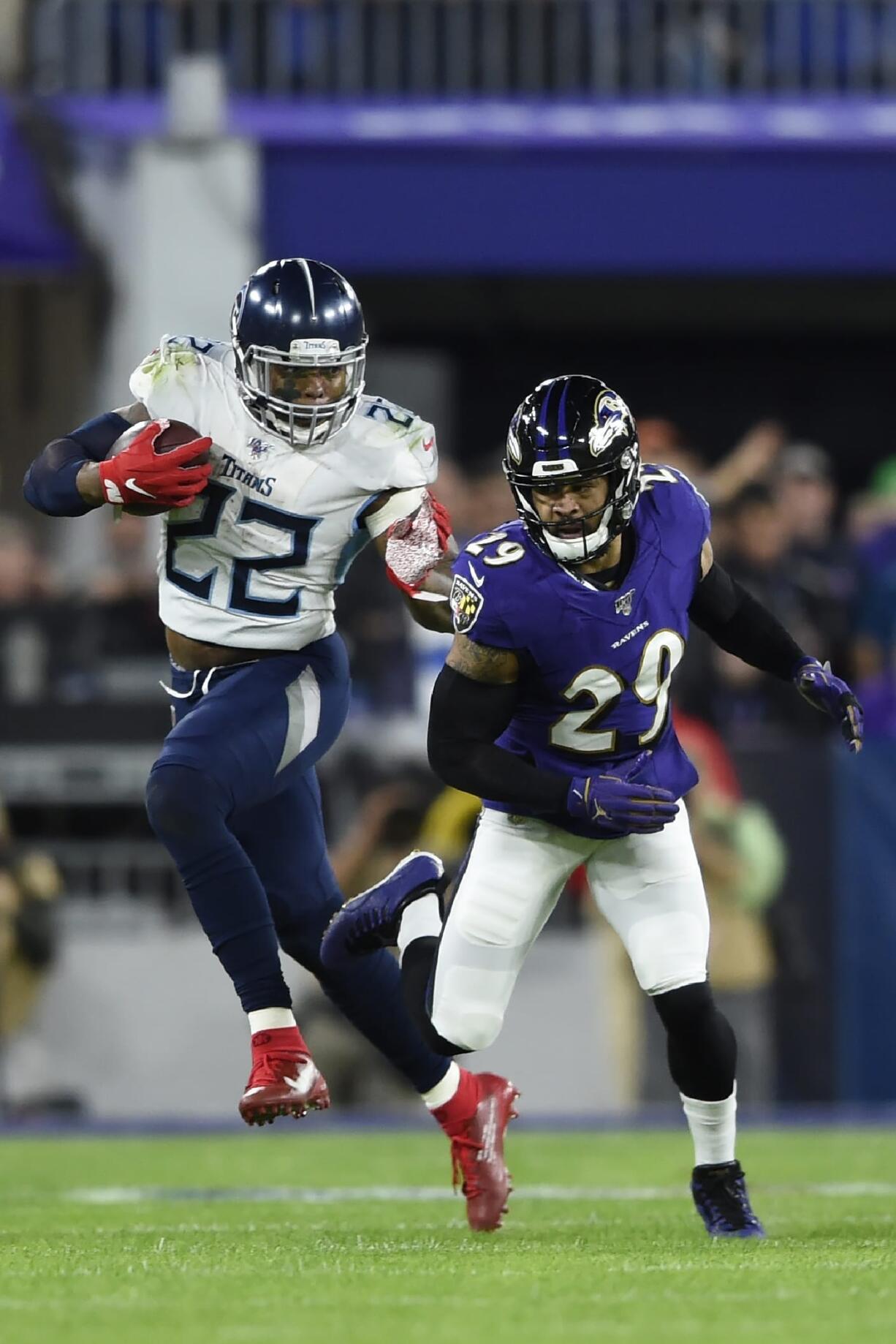 Tennessee Titans running back Derrick Henry (22) runs against Baltimore Ravens free safety Earl Thomas (29) during the first half an NFL divisional playoff football game, Saturday, Jan. 11, 2020, in Baltimore.