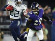 Tennessee Titans running back Derrick Henry (22) runs against Baltimore Ravens free safety Earl Thomas (29) during the first half an NFL divisional playoff football game, Saturday, Jan. 11, 2020, in Baltimore.