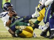 Green Bay Packers' Preston Smith sacks Seattle Seahawks' Russell Wilson during the second half of an NFL divisional playoff football game Sunday, Jan. 12, 2020, in Green Bay, Wis.