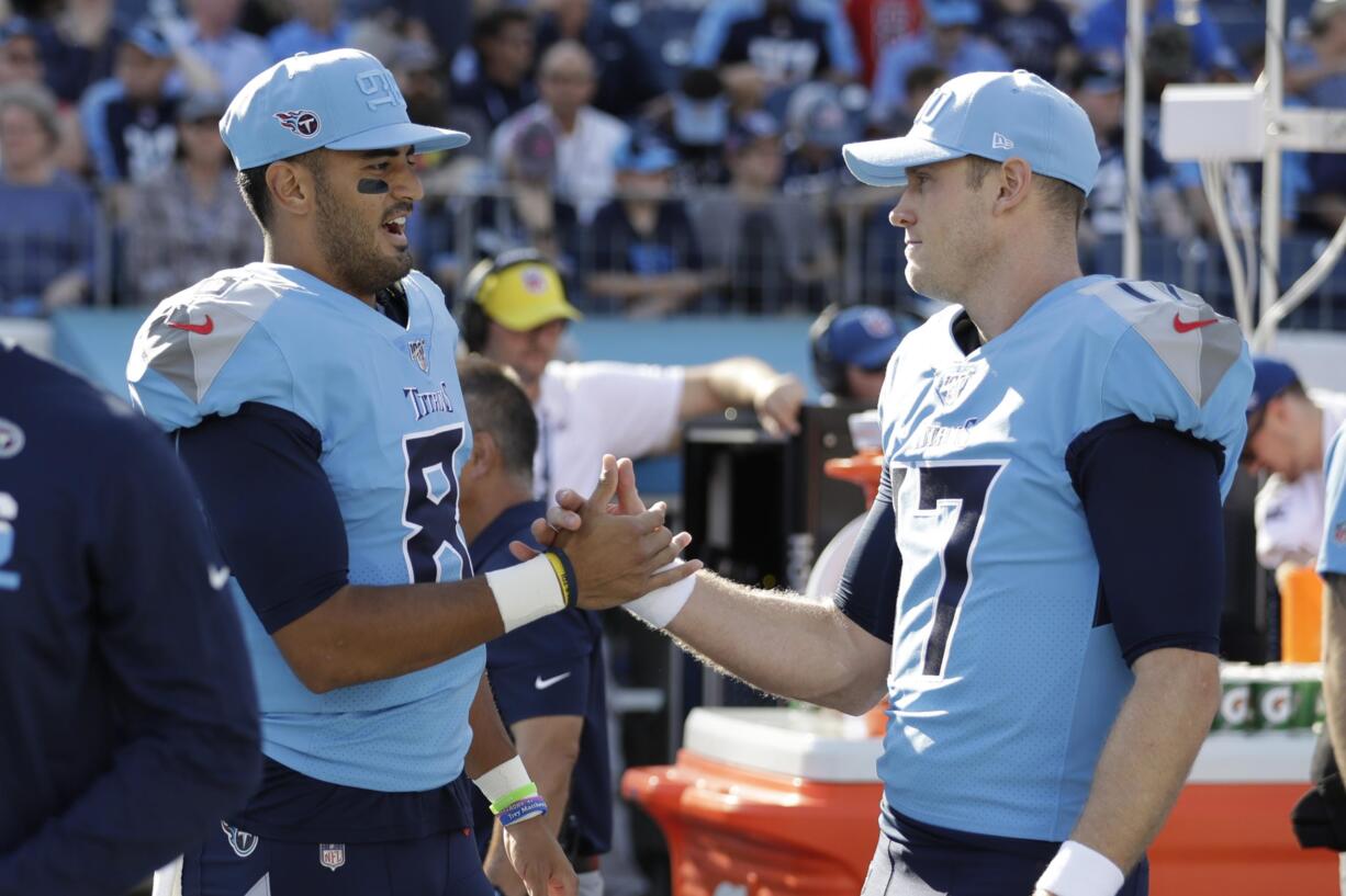 Tennessee Titans quarterbacks Marcus Mariota (8), with fellow QB Ryan Tannehill (17), was benched in mid-October, but he remains valuable to the team mimicking Tom Brady, Lamar Jackson and now Patrick Mahomes in practice for the AFC championship. He's also popped up in three straight games, completing a pass in two and going out for a pass in the last.