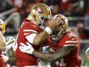 San Francisco 49ers running back Raheem Mostert, right, celebrates his touchdown with quarterback Jimmy Garoppolo during the second half of the NFL NFC Championship football game against the Green Bay Packers Sunday, Jan. 19, 2020, in Santa Clara, Calif.