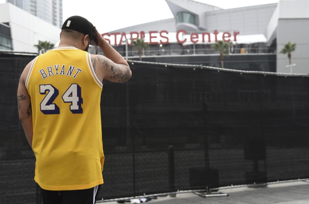 Gennesys Cabral, of Los Angeles, wears a Kobe Bryant jersey outside of the Staples Center at the 62nd annual Grammy Awards on Sunday, Jan. 26, 2020, in Los Angeles. Bryant died Sunday in a helicopter crash near Calabasas, Calif. He was 41.