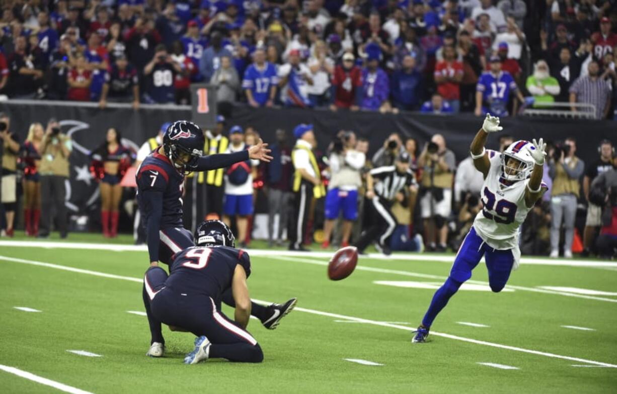 Houston Texans kicker Ka&#039;imi Fairbairn (7) kicks a game-winning 28-yard field goal as Buffalo Bills cornerback Kevin Johnson (29) tries to block the kick during overtime of an NFL wild-card playoff football game Saturday, Jan. 4, 2020, in Houston. The Texans won 22-19.