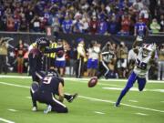 Houston Texans kicker Ka&#039;imi Fairbairn (7) kicks a game-winning 28-yard field goal as Buffalo Bills cornerback Kevin Johnson (29) tries to block the kick during overtime of an NFL wild-card playoff football game Saturday, Jan. 4, 2020, in Houston. The Texans won 22-19.