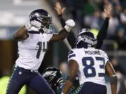 Seattle Seahawks&#039; D.K. Metcalf, left, and David Moore celebrate after Metcalf&#039;s touchdown catch during the second half of an NFL wild-card playoff football game against the Philadelphia Eagles, Sunday, Jan. 5, 2020, in Philadelphia.