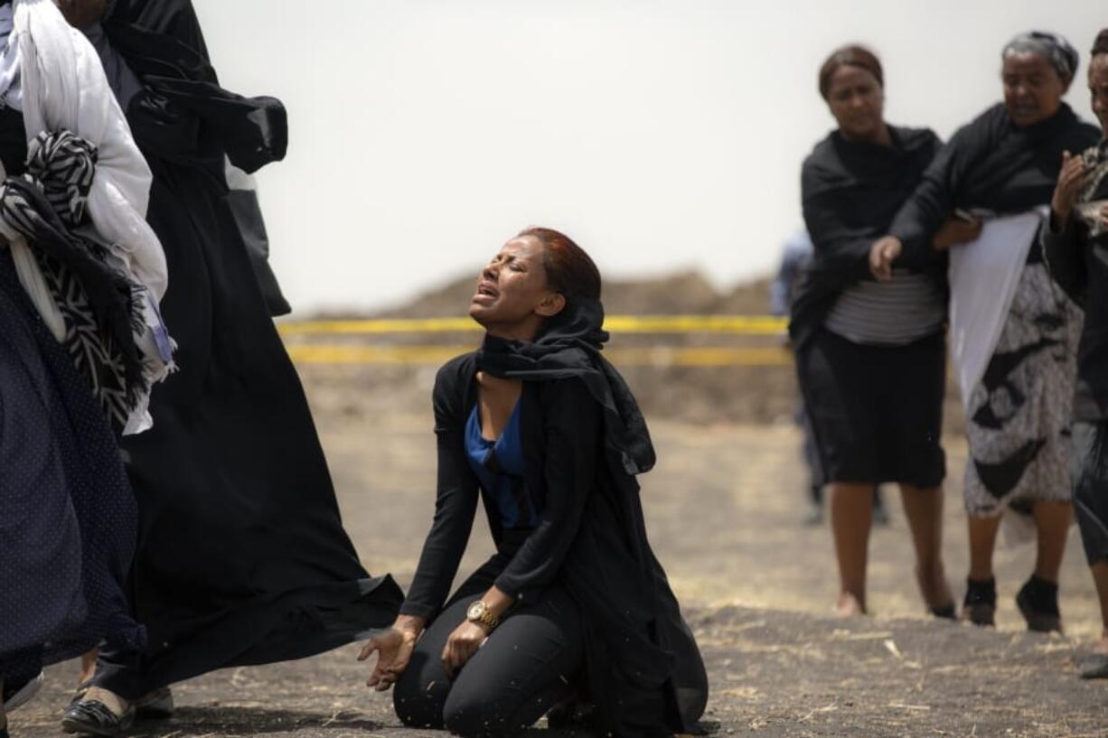 FILE - In this March 14, 2019 file photo, relatives of crash victims mourn at the scene where an Ethiopian Airlines Boeing 737 Max 8 passenger jet crashed shortly after takeoff, killing all 157 on board, near Bishoftu, in Ethiopia. These African stories captured the world&#039;s attention in 2019 - and look to influence events on the continent in 2020.