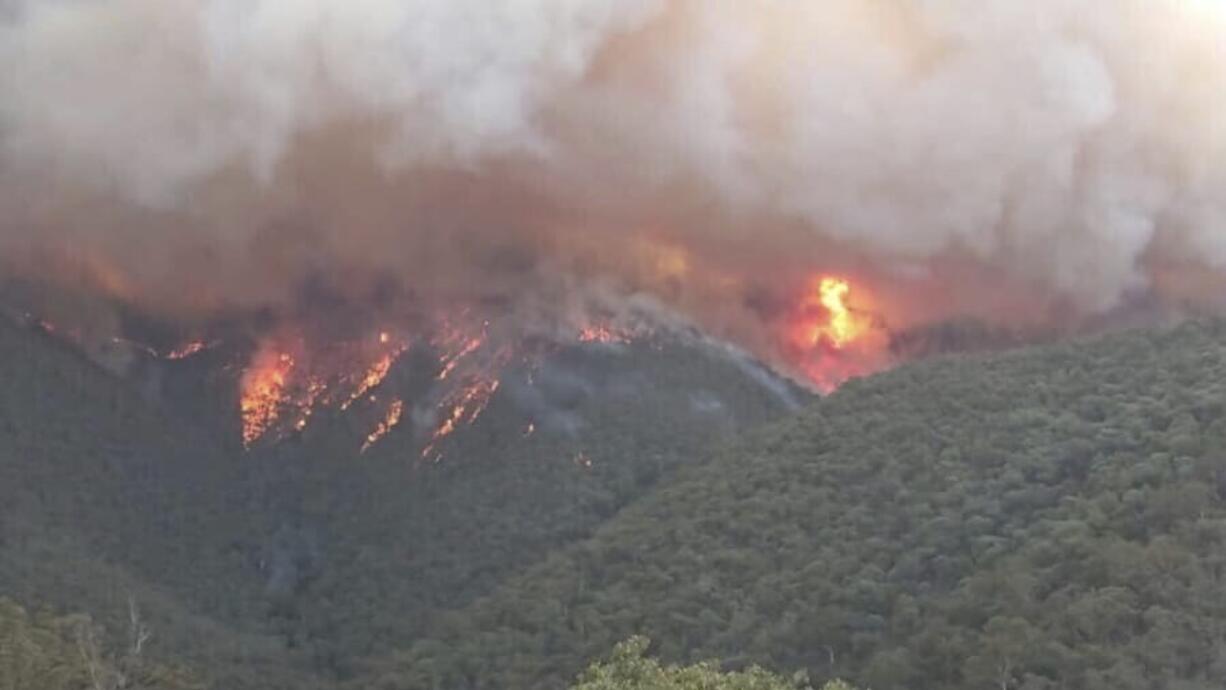 In this image released Thursday, Jan. 2, 2020, from the DELWP Gippland, shows massive smoke rising from wildfires burning in East Gippsland, Victoria. Thousands of tourists are fleeing Australia&#039;s wildfire-ravaged eastern coast ahead of worsening conditions as the military started to evacuate people trapped on the shore further south. Cooler weather has aided firefighting and allowed people to replenish supplies.