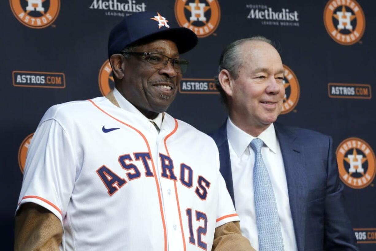 Dusty Baker, left, dons a Houston Astros jersey and cap next to team owner Jim Crane, right, as Baker is announced as the new Astros manager during a news conference at Minute Maid Park Thursday, Jan. 30, 2020, in Houston.