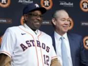 Dusty Baker, left, dons a Houston Astros jersey and cap next to team owner Jim Crane, right, as Baker is announced as the new Astros manager during a news conference at Minute Maid Park Thursday, Jan. 30, 2020, in Houston.