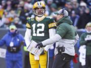 Green Bay Packers head coach Matt LaFleur talks to Aaron Rodgers during the first half of an NFL football game against the Chicago Bears Sunday, Dec. 15, 2019, in Green Bay, Wis.