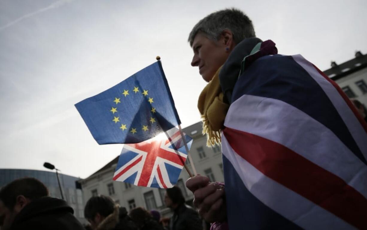 Pro-EU supporter Izzy Knowles, from Birmingham, England, wears a flag with a merger of the Union and EU flags during a ceremony to celebrate British and EU friendship outside the European Parliament in Brussels, Thursday, Jan. 30, 2020. The European Union grudgingly let go of the United Kingdom with a final vote Wednesday at the EU&#039;s parliament that ended the Brexit divorce battle and set the scene for tough trade negotiations in the year ahead.