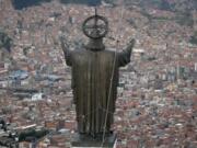 A Christ statue overlooks El Alto, a city adjoining the capital city La Paz, Bolivia. Ancestral indigenous practices became more visible during the presidency of Evo Morales, who recognized the Andean earth deity Pachamama.