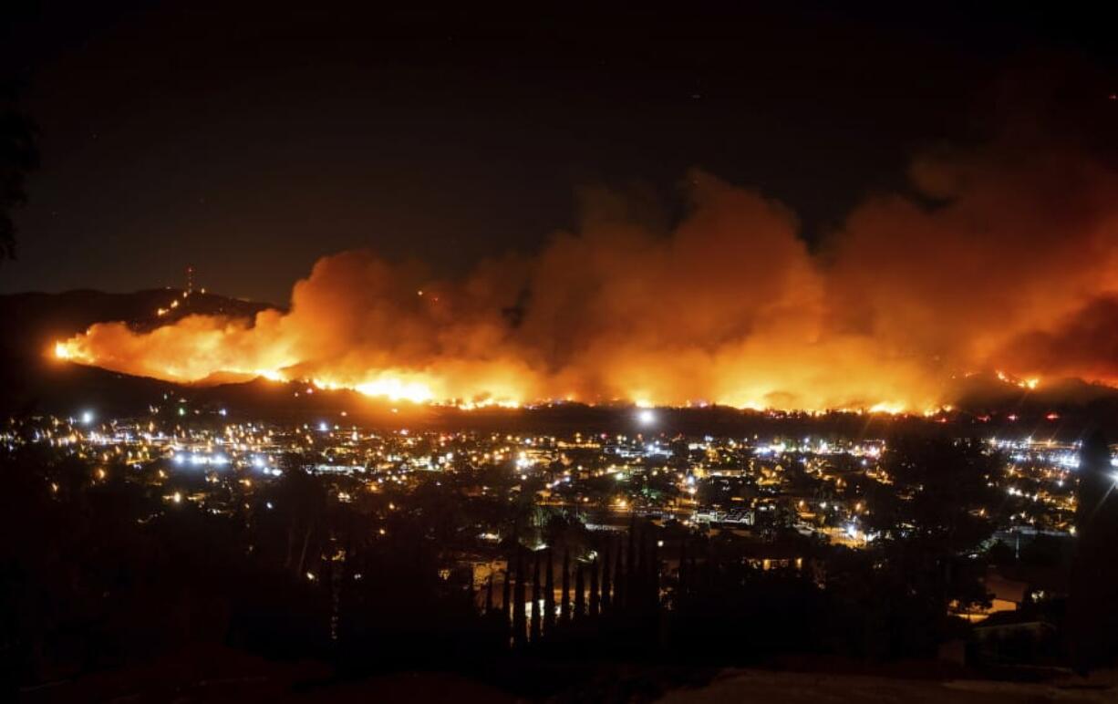 FILE - In this Oct. 31, 2019, file photo, smoke from a wildfire known as the Maria Fire billows above Santa Paula, Calif. California&#039;s preemptive power shutoffs to prevent wildfires have affected more than just lights. Some lost their phones, too.