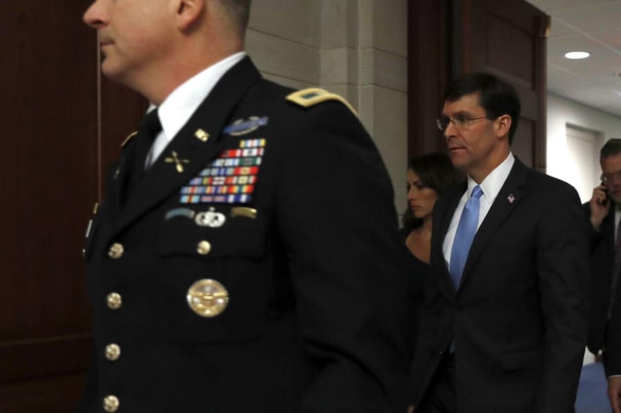 Defense Secretary Mark Esper arrives to brief members of the Senate on the details of the threat that prompted the U.S. to kill Iranian Gen. Qassem Soleimani in Iraq, Wednesday, Jan. 8, 2020 on Capitol Hill in Washington.