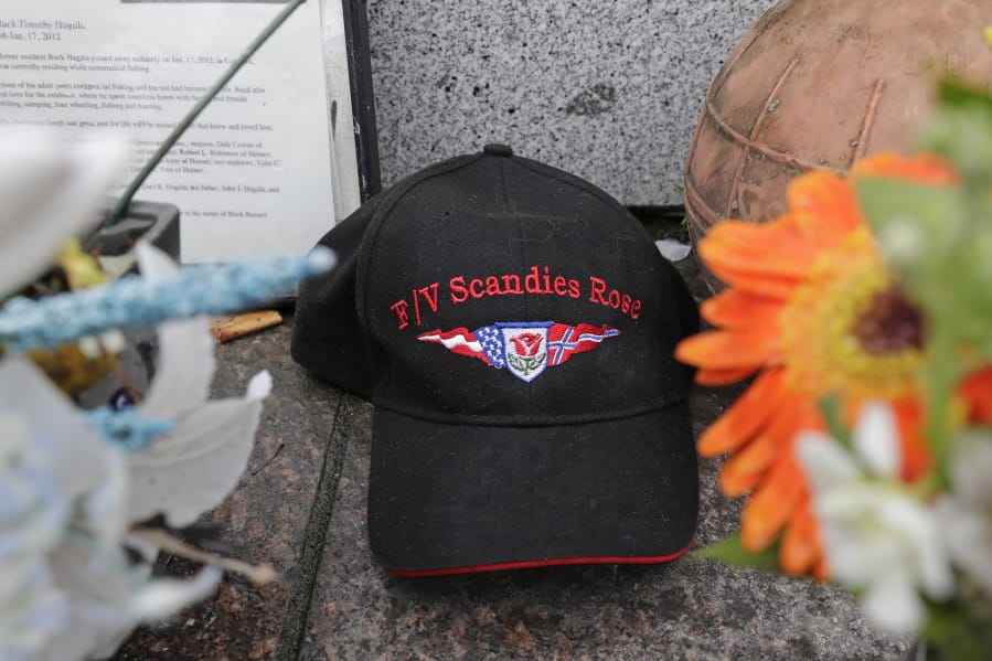 A ball cap with the name of the crab fishing boat Scandies Rose rests at the Seattle Fishermen&#039;s Memorial, Thursday, Jan. 2, 2020, in Seattle. The search for five crew members of the Scandies Rose in Alaska has been suspended, the U.S. Coast Guard said after two other crew members of the vessel were rescued after the 130-foot crab fishing boat from Dutch Harbor, Alaska, sank on New Year&#039;s Eve. (AP Photo/Ted S.