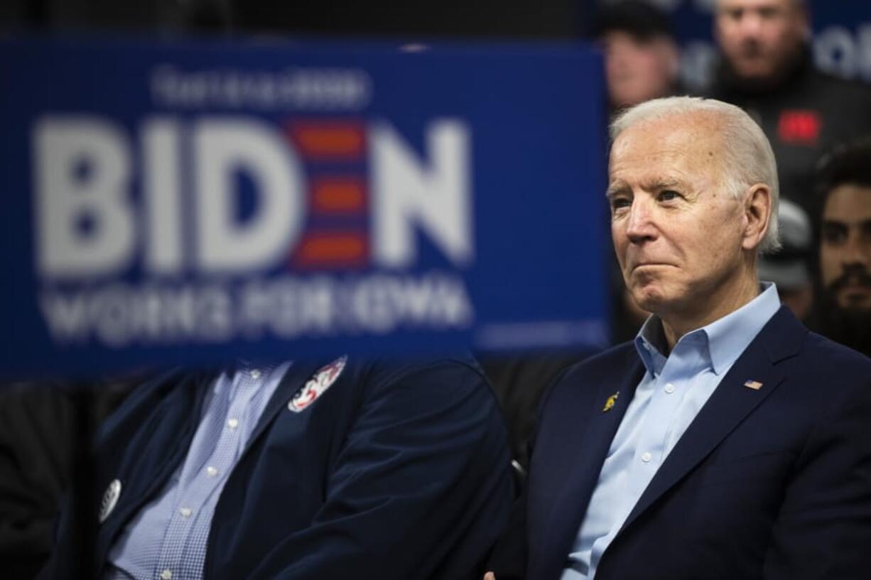 Democratic presidential candidate former Vice President Joe Biden listens to his introduction at a campaign event with the International Association of Bridge, Structural, and Ornamental Iron Workers, Sunday, Jan. 26, 2020, in Des Moines, Iowa.