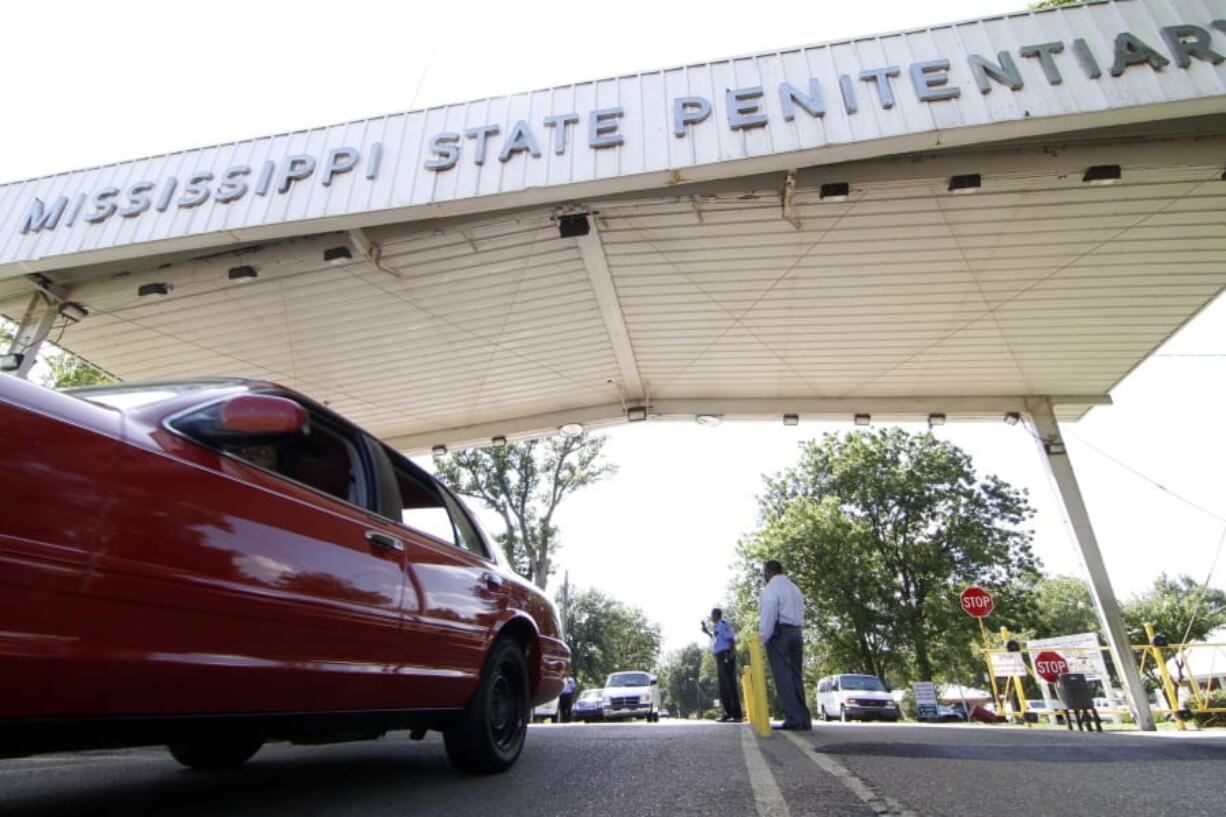 FILE - In this July 21, 2010, photograph, employees leave the front gate of the Mississippi State Penitentiary in Parchman, Miss. Another Mississippi inmate died at the hands of a fellow inmate, Thursday, Jan. 2, 2020, this time, at the penitentiary, bringing the death toll to four amid disturbances over the past week in the state prison system. The violence comes even as a federal judge, Tuesday, Dec. 31, 2019, rejected claims that conditions in one Mississippi prison are unconstitutionally harsh. (AP Photo/Rogelio V.