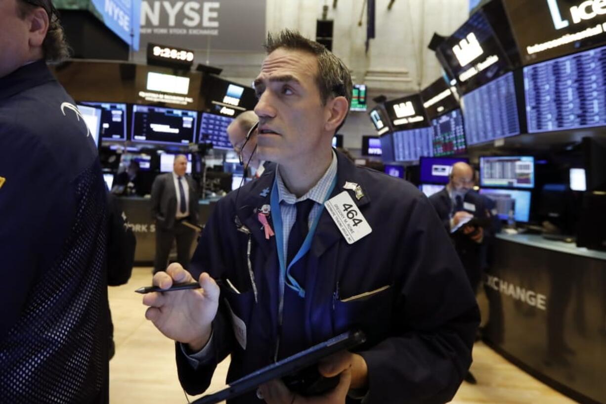 FILE - In this Jan. 10, 2020, file photo trader Gregory Rowe works on the floor of the New York Stock Exchange. The U.S. stock market opens at 9:30 a.m. EST on Friday, Jan.