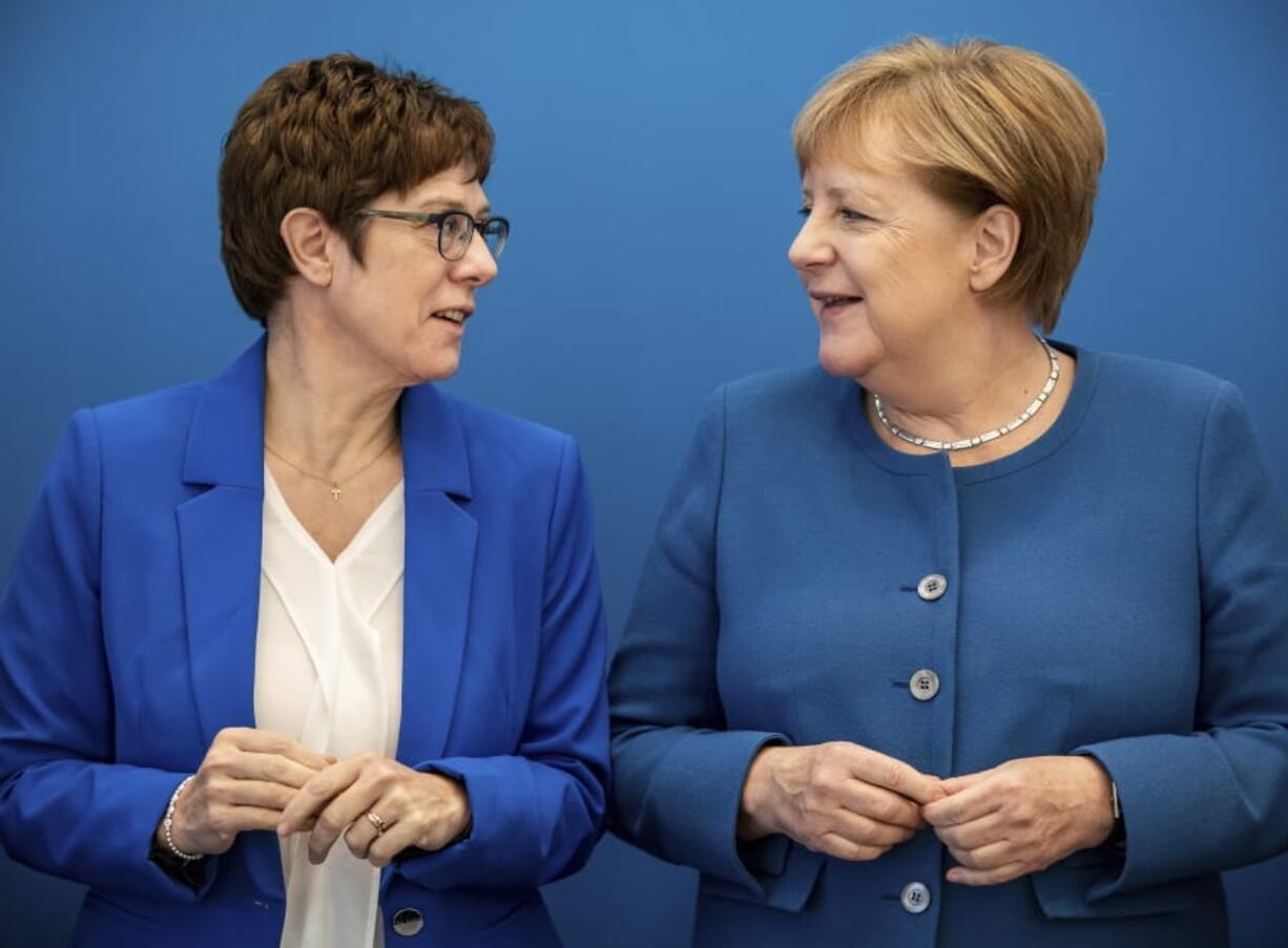 Annegret Kramp-Karrenbauer, left, CDU Federal Chairman and Defence Minister, stands next to Chancellor Angela Merkel (CDU) at the beginning of the meeting of the CDU Federal Executive Committee in the Konrad-Adenauer-Haus in Berlin, German, Monda, Dec.9, 2019.