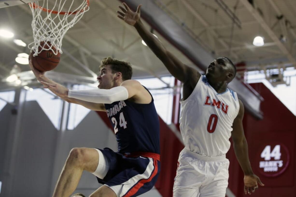 Gonzaga forward Corey Kispert, left, drives past Loyola Marymount guard Eli Scott, right, during the first half of an NCAA college basketball game in Los Angeles, Saturday, Jan. 11, 2020.