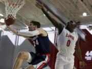 Gonzaga forward Corey Kispert, left, drives past Loyola Marymount guard Eli Scott, right, during the first half of an NCAA college basketball game in Los Angeles, Saturday, Jan. 11, 2020.