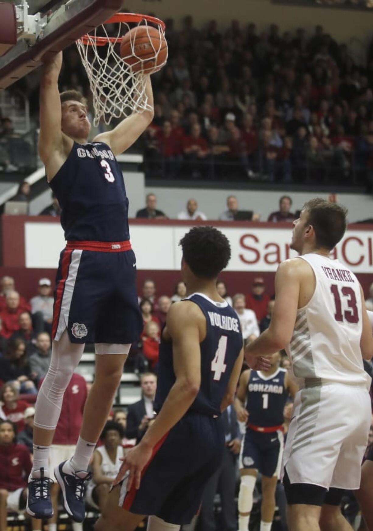 Gonzaga forward Filip Petrusev (3) dunks in front of guard Ryan Woolridge (4) and Santa Clara forward Josip Vrankic (13) during the first half of an NCAA college basketball game in Santa Clara, Calif., Thursday, Jan. 30, 2020.