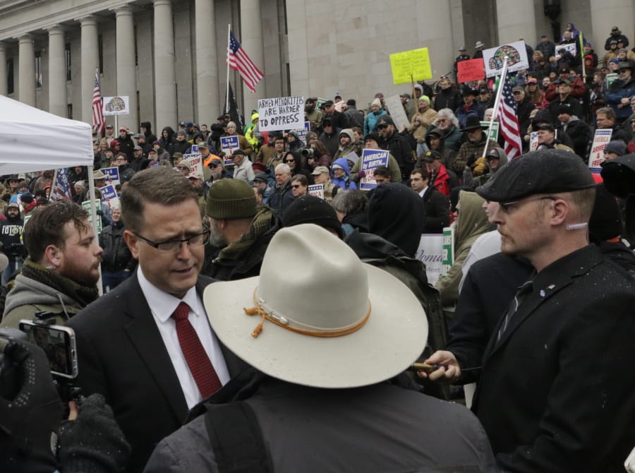 Republican Rep. Matt Shea meets with supporters after speaking at a gun-rights rally in Olympia, Wash., Friday, Jan. 17, 2020. Shea was suspended from the Republican caucus in the wake of a December report that found he was involved in anti-government activities and several lawmakers have called on him to resign. Shea, who says he&#039;s been targeted for his work against anti-gun bills, says he will not resign and will run for re-election this year.