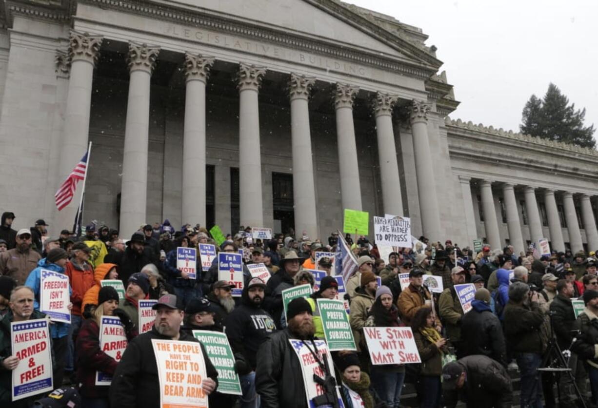 Gun-rights supporters rally on the steps of the Washington Capitol, in Olympia, Wash., Friday, Jan. 17, 2020. Several Republican lawmakers spoke at the rally decrying gun control measures being considered by the Legislature this year.