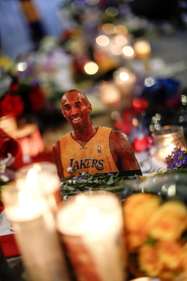 A picture of the late Kobe Bryant is displayed at a memorial near Staples Center, Tuesday, Jan. 28, 2020, in Los Angeles. Bryant, the 18-time NBA All-Star who won five championships and became one of the greatest basketball players of his generation during a 20-year career with the Los Angeles Lakers, died in a helicopter crash Sunday. (AP Photo/Ringo H.W.