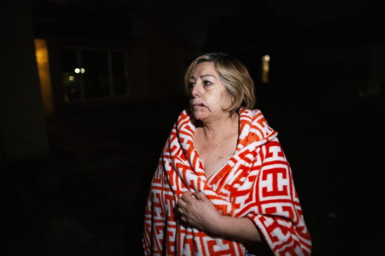 Maria Olivo, a west Houston resident, is shown after a massive explosion blew the window in the room she was sleeping in on Friday, Jan. 24, 2020, in Houston. A massive explosion early Friday leveled a warehouse in Houston and damaged nearby buildings and homes, rousing frightened people from their sleep miles away.  (Marie D.