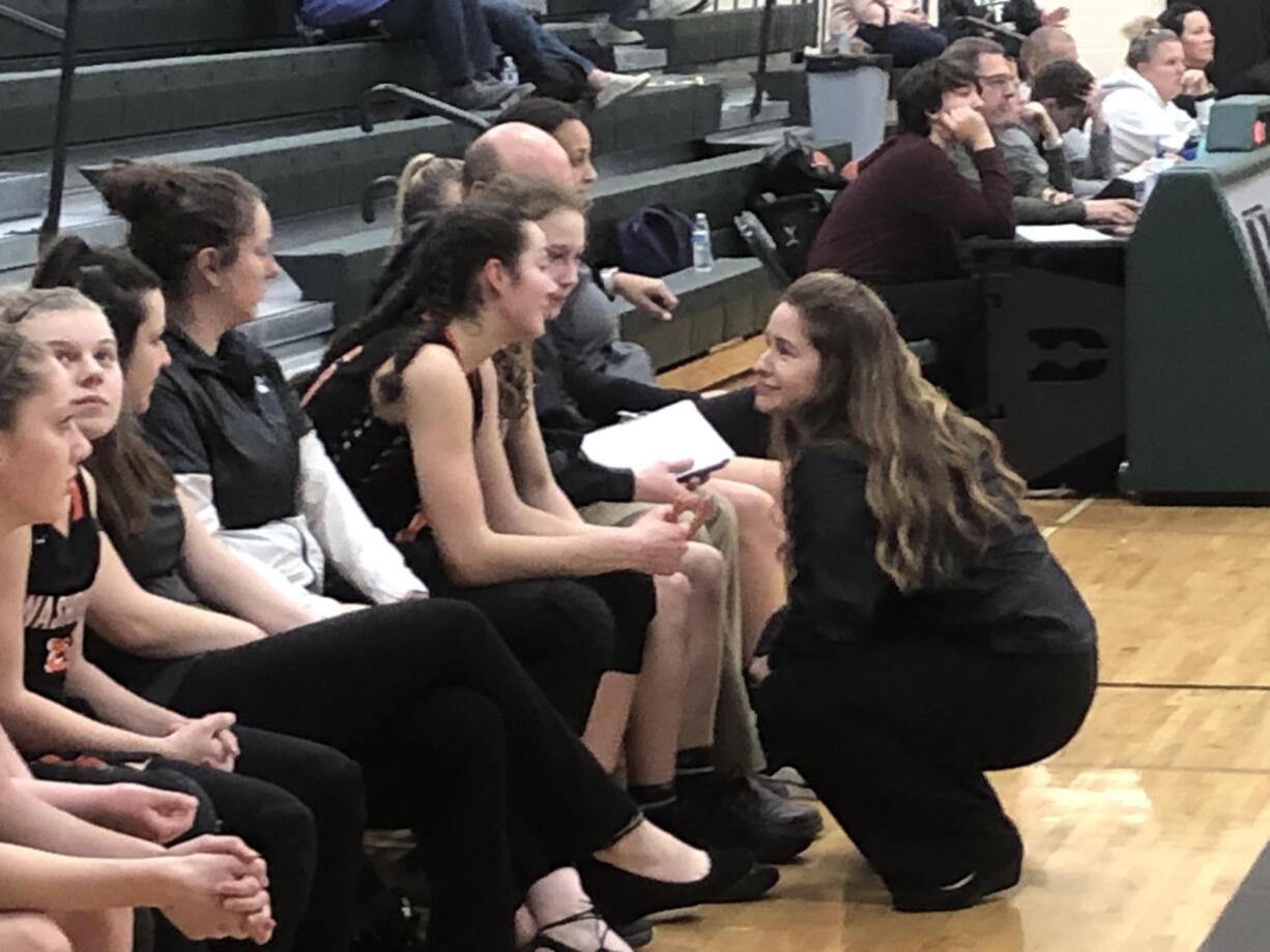 Washougal girls basketball coach Britney Ervin, right, talks with forward Skylar Bea during the Panthers' 75-31 win over Woodland on Wednesday at Woodland High.