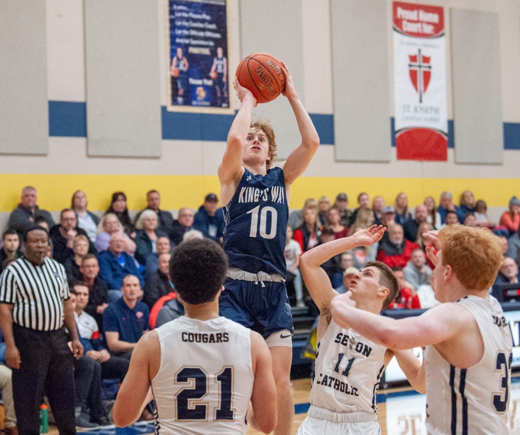 King's Way Christian's Bryson Metz makes a jumper over Seton Catholic defenders in the Knights' 75-65 win on Wednesday.