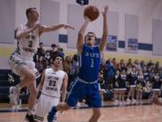 La Center's Hunter Ball (1) takes a shot as Seton Catholic's Kellen Ball (3) and Gabe Anderson (23) in La Center's 71-67 win over Seton Catholic. (Photo courtesy of N.