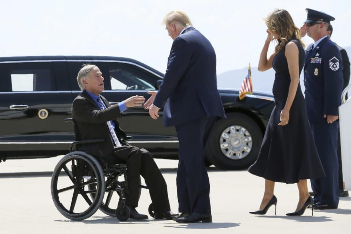 FILE - In this Aug. 7, 2019 file photo, President Donald Trump and Melania Trump greet Texas Gov. Greg Abbott after arriving in El Paso, Texas. Abbott says the state will reject the re-settlement of new refugees, becoming the first state known to do so under a recent Trump administration order.