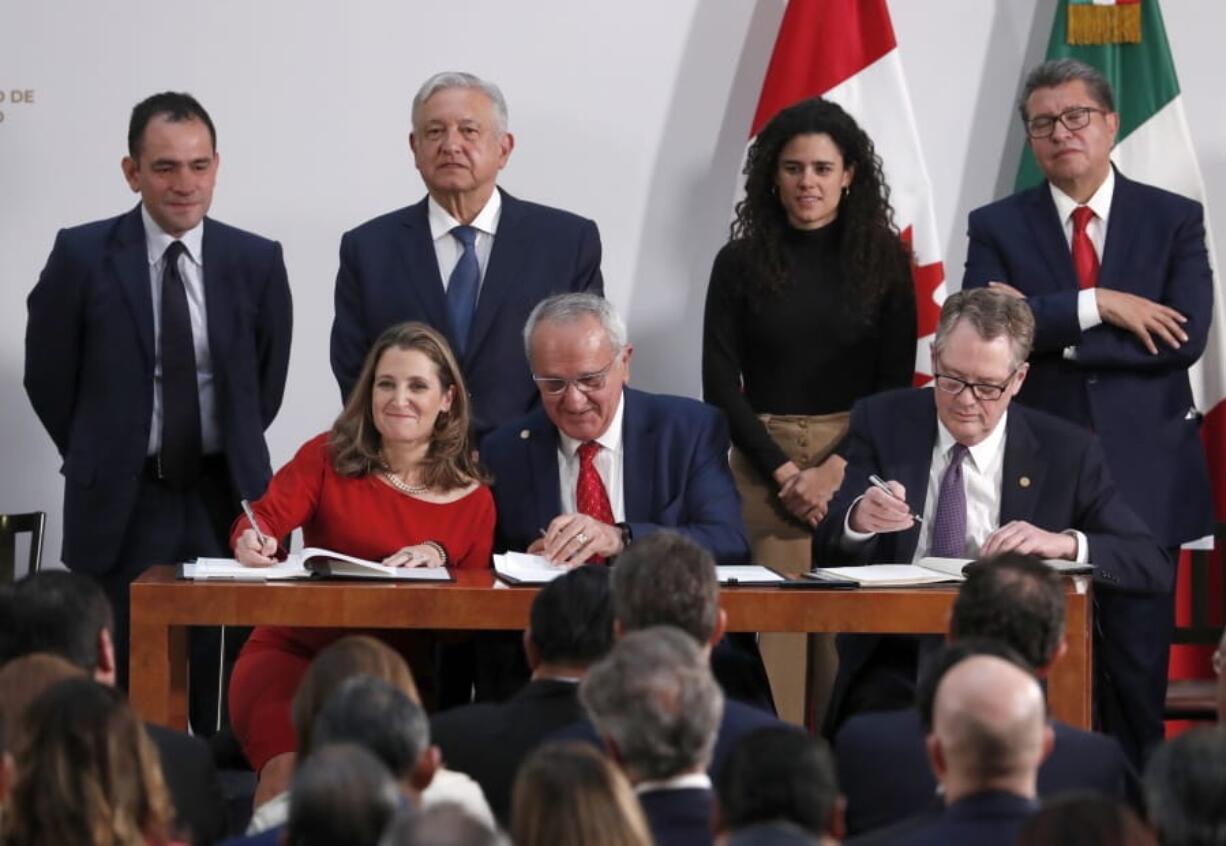 Deputy Prime Minister of Canada Chrystia Freeland, left, Mexico&#039;s top trade negotiator Jesus Seade, center, and U.S. Trade Representative Robert Lighthizer, sign an update to the North American Free Trade Agreement, at the national palace in Mexico City, Tuesday, Dec. 10. 2019. Observing from behind are Mexico&#039;s Treasury Secretary Arturo Herrera, left, Mexico&#039;s President Andres Manuel Lopez Obrador, second left, Mexico&#039;s Labor Secretary Maria Alcade, third left, and The President of the Mexican Senate Ricardo Monreal.