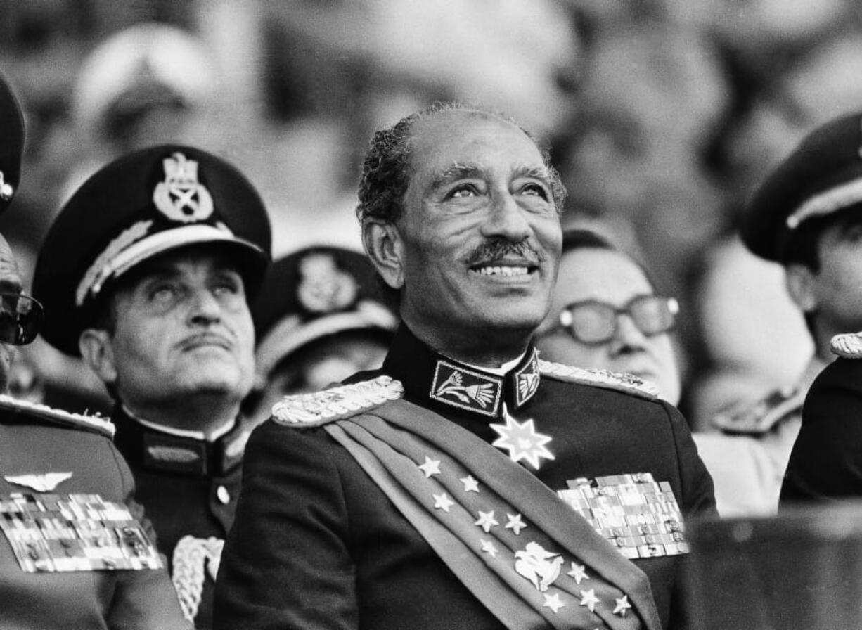 FILE - In this Oct. 6, 1981 file photo, Egyptian President Anwar Sadat smiles at the start of the military parade in Cairo. Later, during the parade, Sadat was killed with eleven others when gunmen opened fire on the reviewing stand with automation weapons.